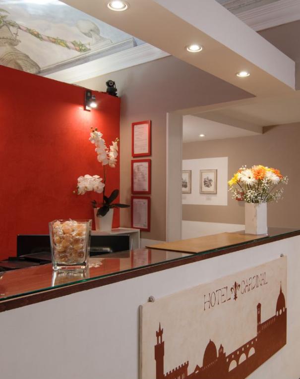 Hotel Cardinal reception with floral decorations and artworks.
