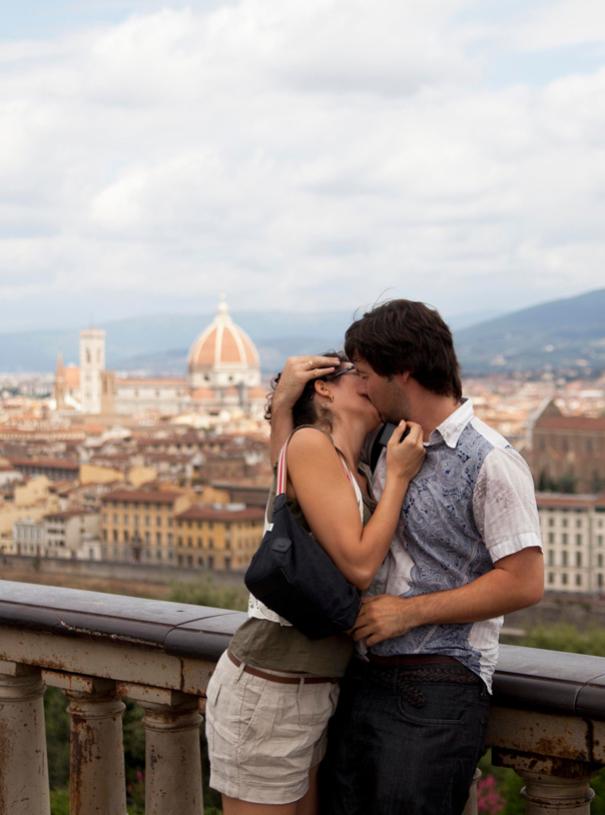 Couple kissing with Florence in the background.